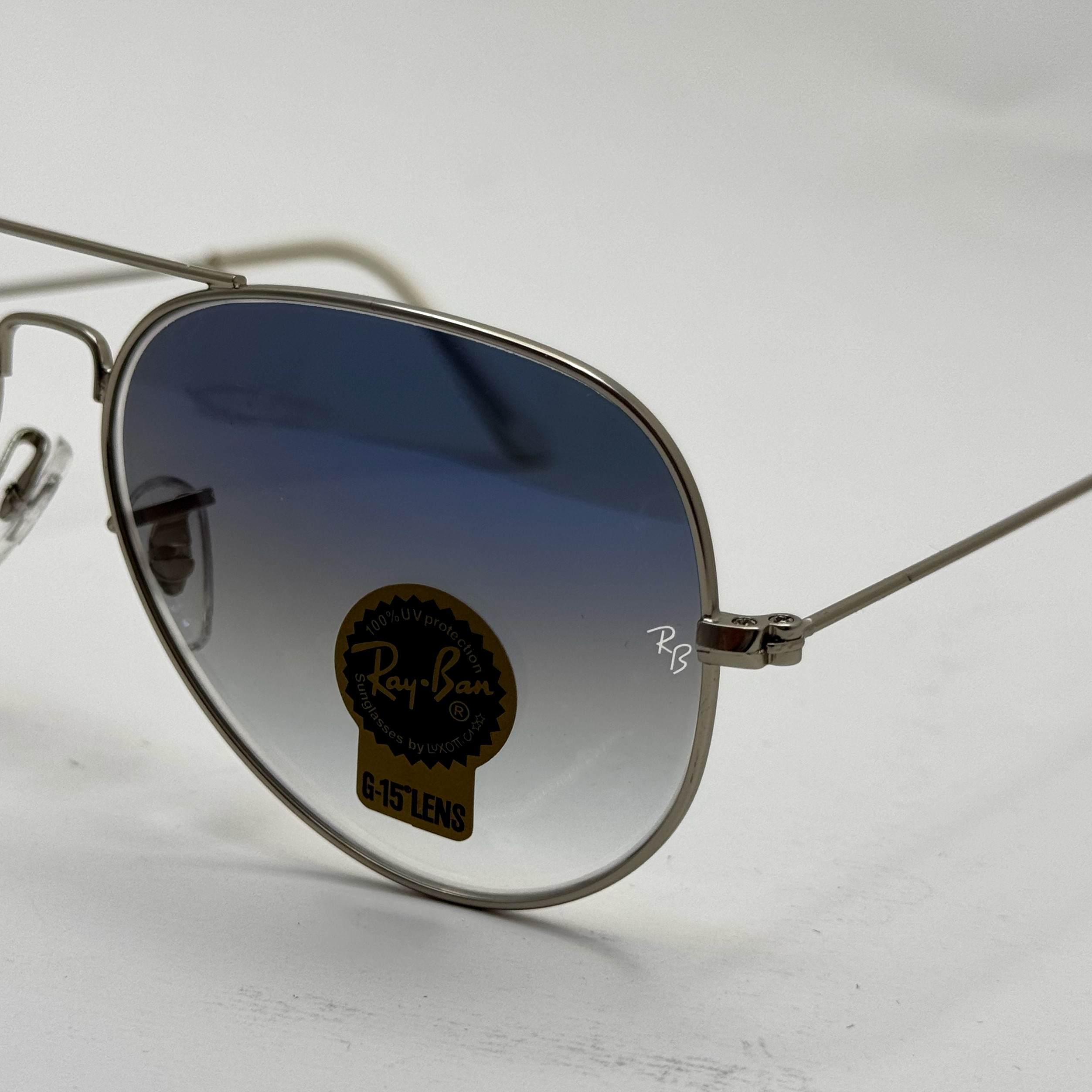 عینک ریبن خلبانی شیشه سنگ آبی هایلایت فریم نقره ای به همراه پک کامل ریبن کد Rayban RB 3025 (ارسال رایگان)